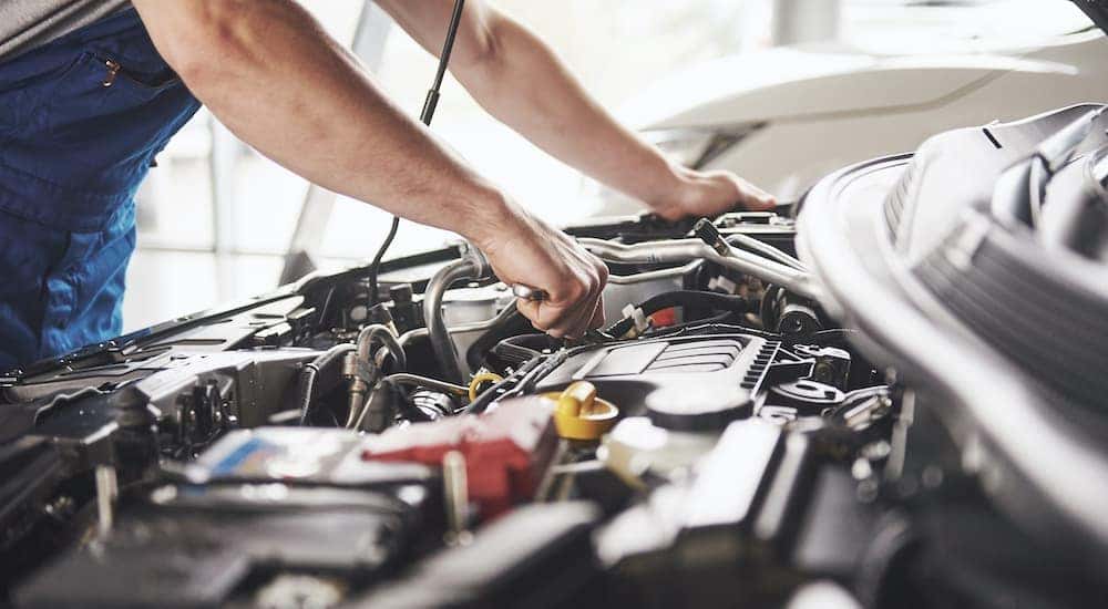 A mechanic is preforming an affordable auto service.