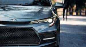 A close up shows the driver side headlight of a grey 2021 Toyota Corolla XSE after leaving a Joliet car dealer.