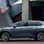 A grey 2022 Toyota Corolla Cross LXE AWD is shown from the side parked in a city after leaving a Joliet car dealer.