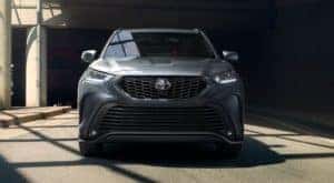 A grey 2021 Highlander XSE AWD is sown from the front parked in a concrete building.