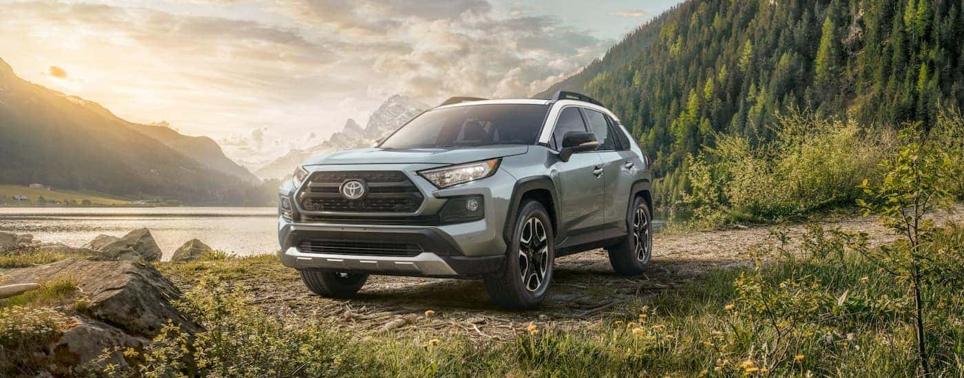 A grey 2022 RAV4 Adventure grade is shown parked in the mountains after leaving a Toyota SUV dealer.