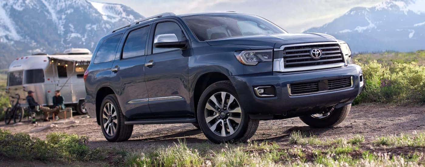 A blue 2022 Sequoia Limited is shown from the side parked in the mountains.