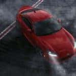 A red 2022 Toyota GR86 is shown at a track after leaving a Toyota 86 dealership.