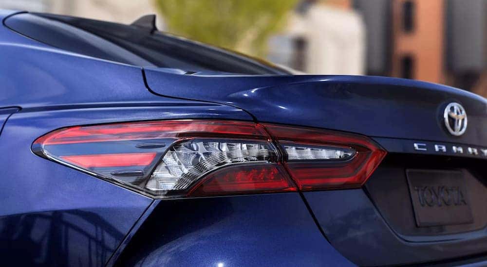 A close up of a blue 2022 Toyota Camry XLE shows the rear taillight at a Toyota Camry dealership.