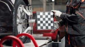 A mechanic is shown performing an auto alignment near you.
