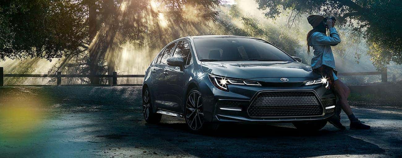 A grey 2020 Toyota Corolla is shown parked in a shade-covered parking area.