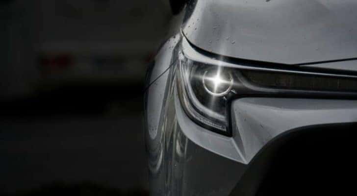 A close up of a LED headlight on a silver sedan is shown.