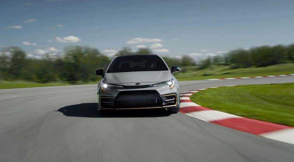 A grey 2022 Toyota Corolla XSE Apex Edition is shown driving on a race track after leaving Naperville Toyota dealer.