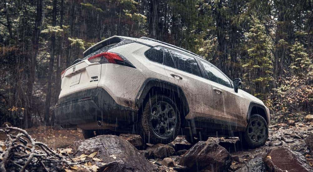A white 2022 Toyota RAV4 TRD is shown from the side off-roading after leaving a SUV dealer near me.