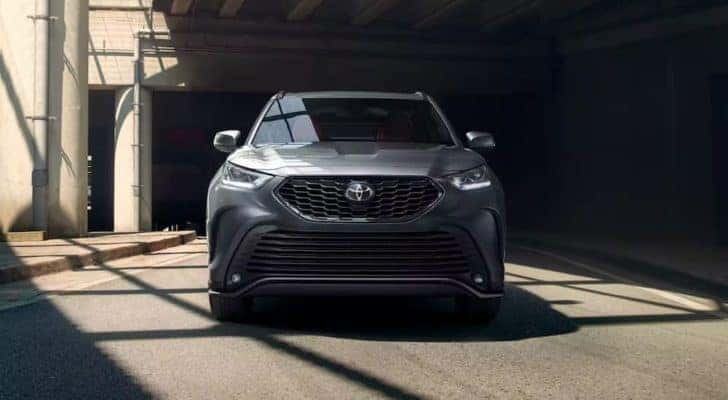A grey 2022 Toyota Highlander is shown from the front parked in a garage.