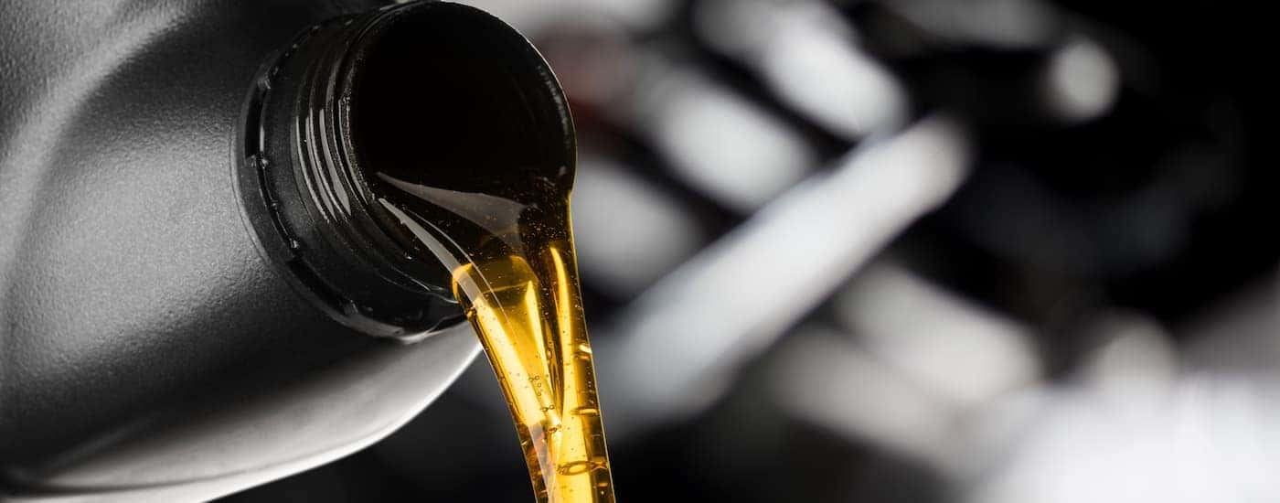 A bottle of oil is shown being poured.