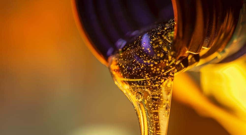 Motor oil is shown flowing out of a bottle.