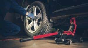 A mechanic is shown changing a tire.