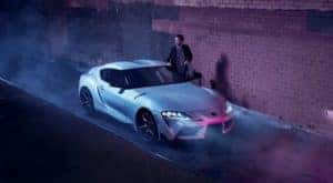 A silver 2020 Toyota Supra is shown from the front in a dark alley after leaving a certified Toyota dealer.