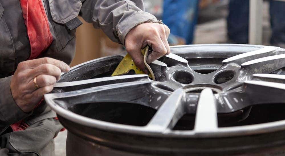 A mechanic is shown repairing a wheel.