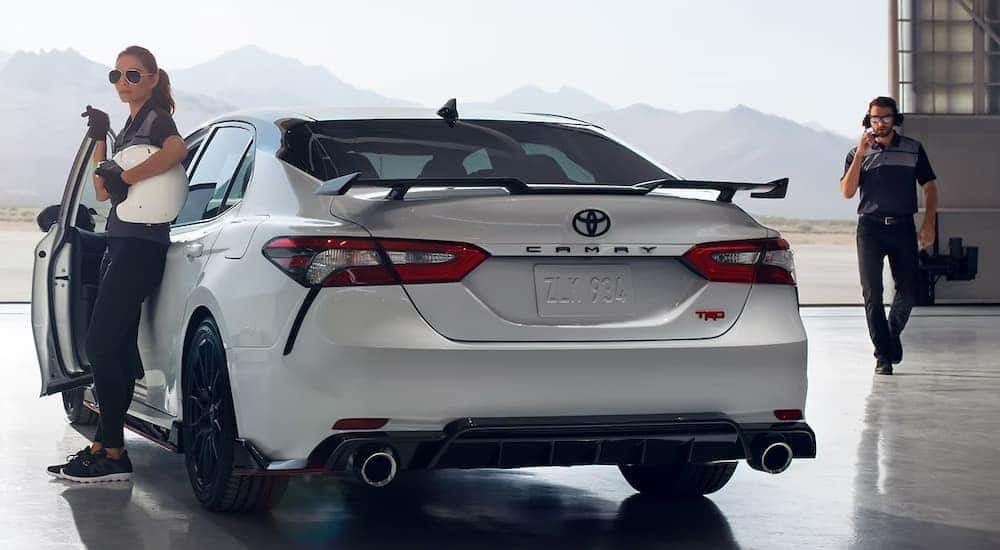 A white 2023 Toyota Camry TRD is shown from the rear at an angle.