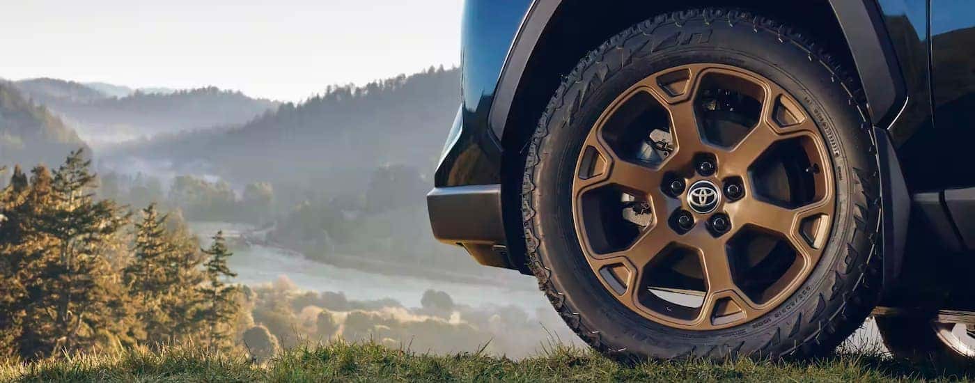 A close up shows the bronze wheel on a 2023 Toyota RAV4 Hybrid Woodland Edition.