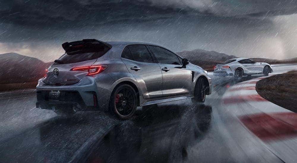 A grey 2023 Toyota GR Corolla is shown from the rear at an angle while drifting.