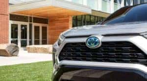 A close up shows the grille on a silver 2023 Toyota RAV4 Hybrid XSE after visiting a Toyota dealer near Naperville, IL.