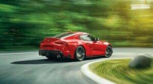 A red 2021 Toyota Supra is shown from the rear after getting a Toyota tire rotation.