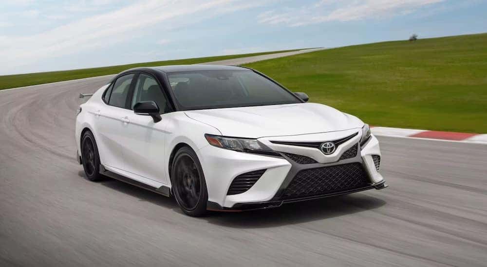 A white 2023 Toyota Camry TRD is shown from the front at an angle.