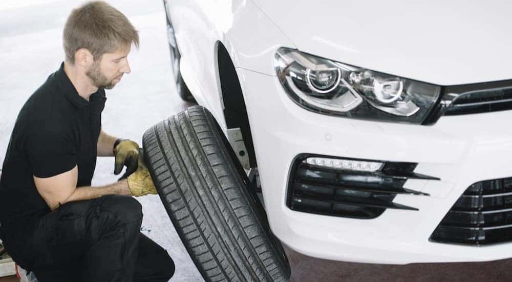 A mechanic is shown installing Toyota summer tires for sale.