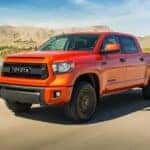 An orange 2015 Toyota Tundra is shown from the front at an angle after leaving a Toyota service center near Darien, IL.