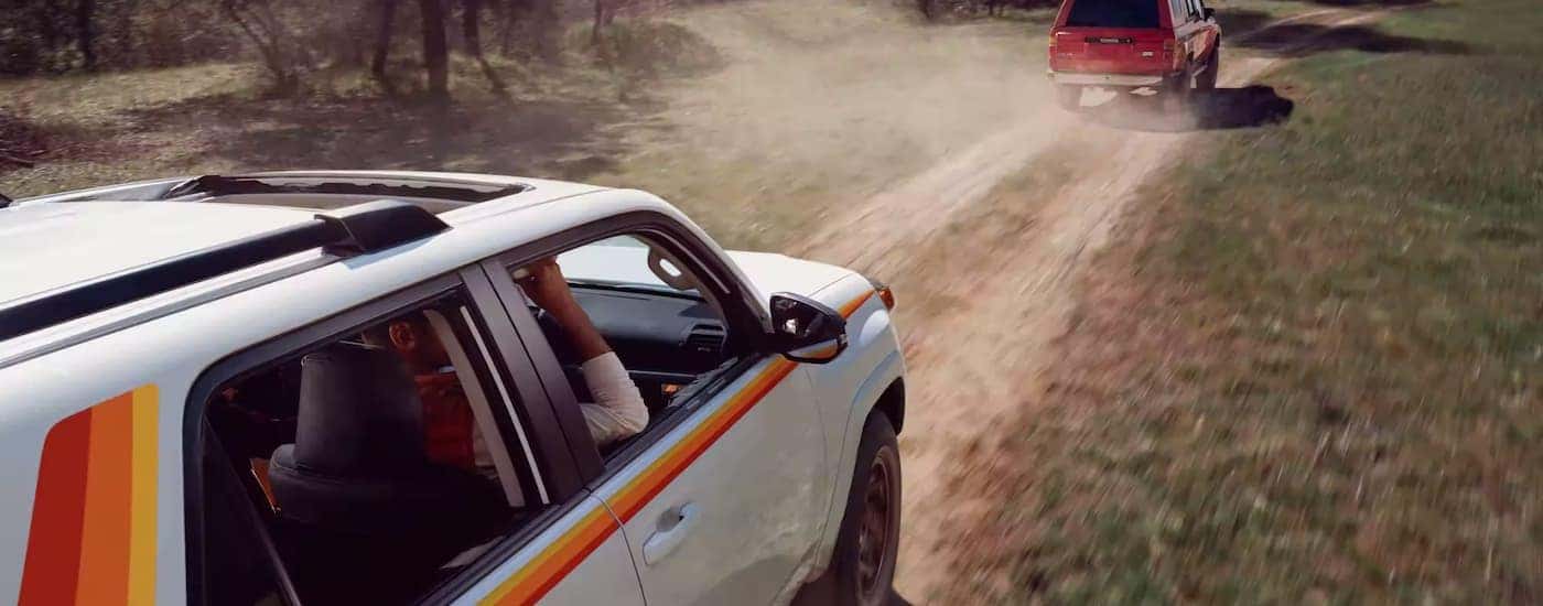 A white 2023 Toyota 4Runner 40th Anniversary Edition is shown driving on a dusty dirt road.