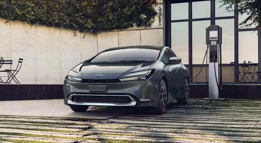 A grey 2023 Toyota Prius Prime XSE Premium is shown charging.
