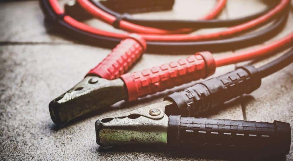Jumper cables are shown on tiles.