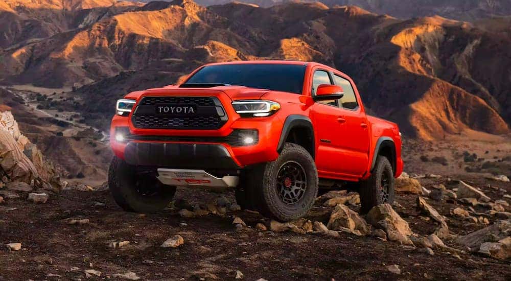 A red 2023 Toyota Tacoma TRD Pro is shown parked off-road.