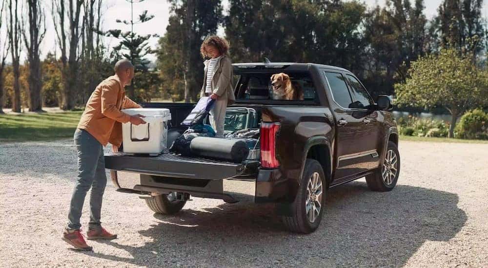 A black 2024 Toyota Tundra is shown parked off-road.