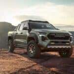 A green 2024 Toyota Tacoma Trailhunter is shown from the front at an angle.