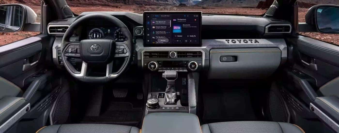The interior and dash are shown in a 2024 Toyota Tacoma for sale.