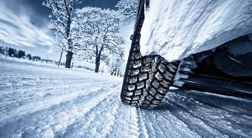 A vehicle is shown parked on a snowy road.