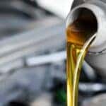Oil is shown being poured during a Toyota oil change.