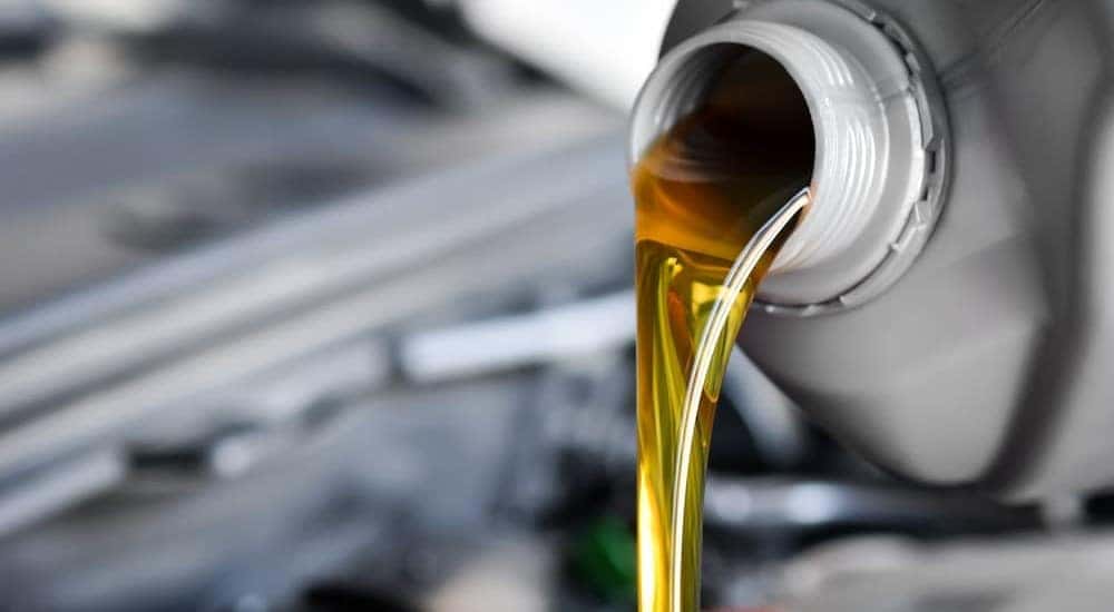 Oil is shown being poured during a Toyota oil change.