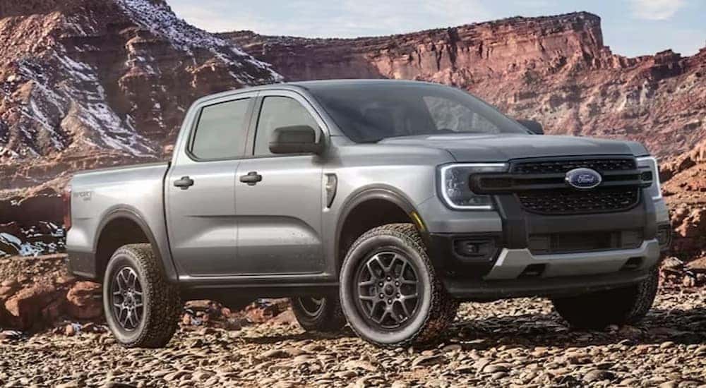 A gray 2024 Ford Ranger is shown parked on rocks.