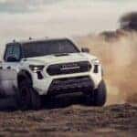 A white 2024 Toyota Tacoma TRD Pro is shown from the front at an angle after leaving a Toyota Tacoma dealer.