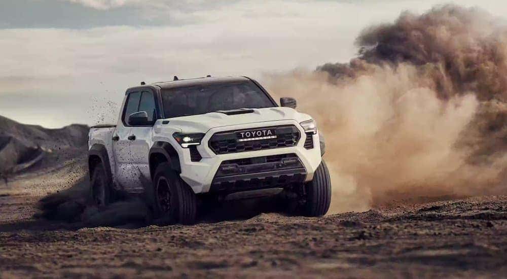 A white 2024 Toyota Tacoma TRD Pro is shown from the front at an angle after leaving a Toyota Tacoma dealer.