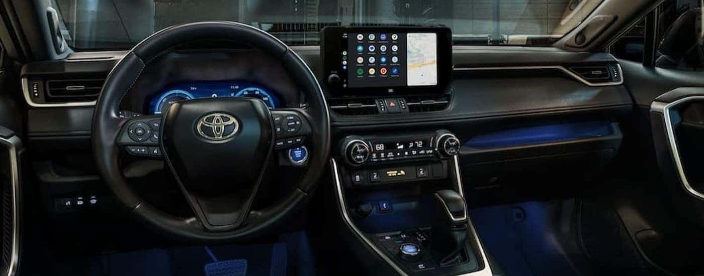 The black interior and dash of a 2024 Toyota RAV4 is shown.