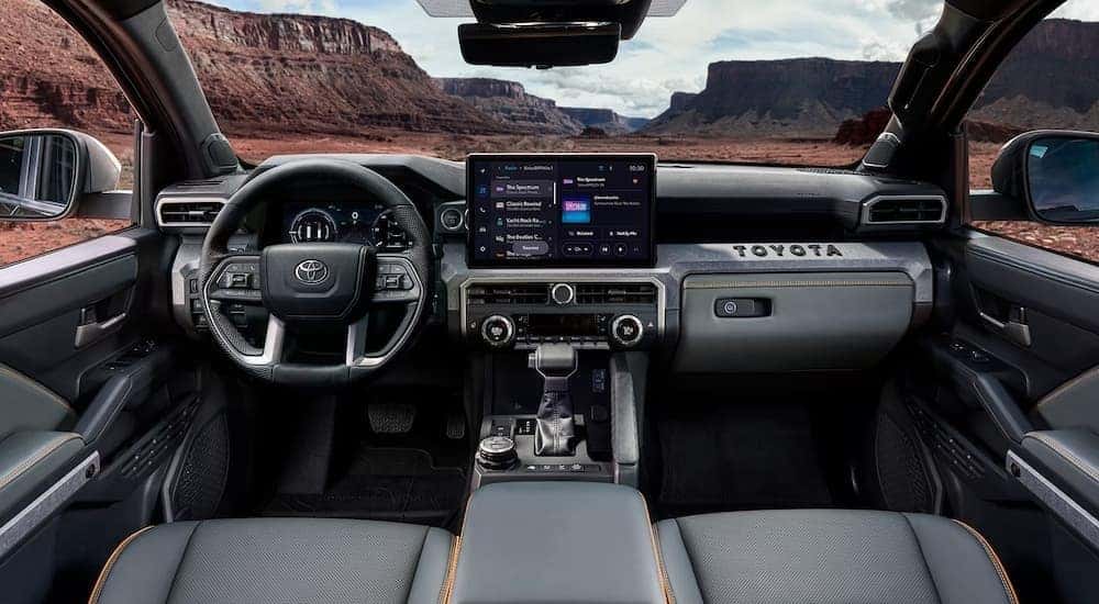 The gray interior and dash in a 2024 Toyota Tacoma is shown.