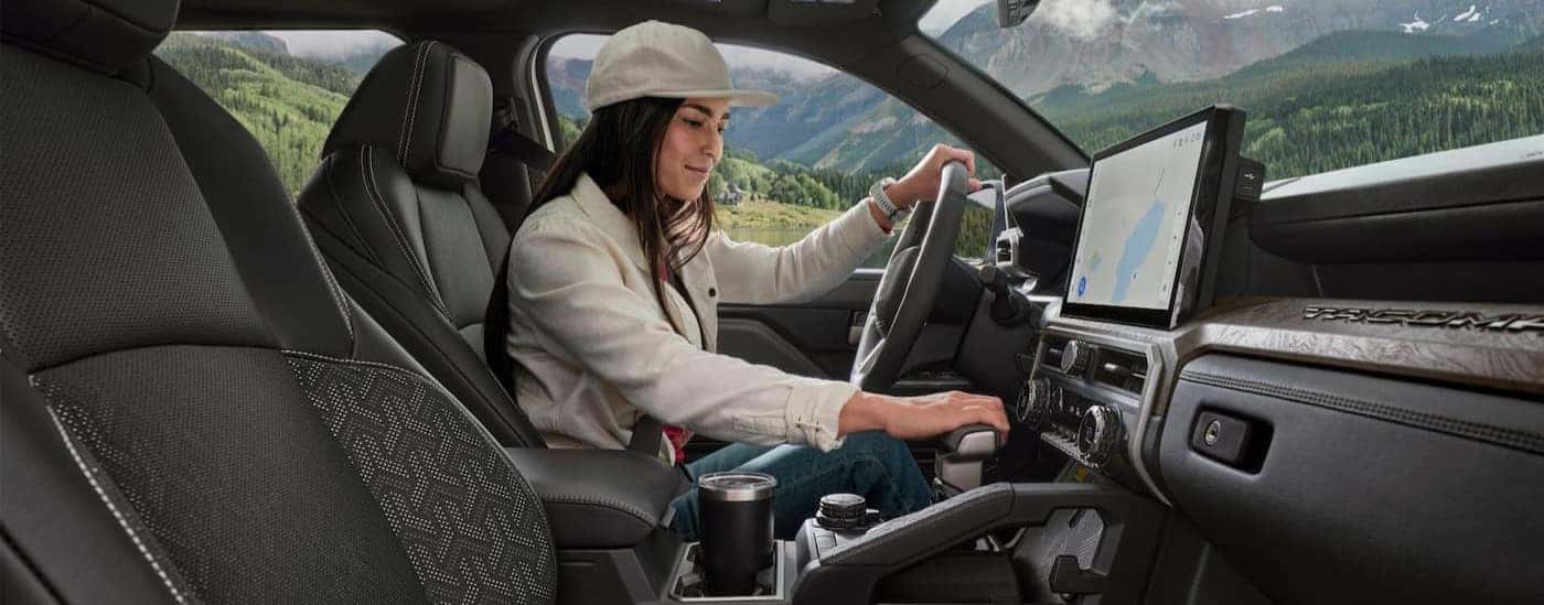 The black interior and dash in a 2024 Toyota Tacoma is shown.