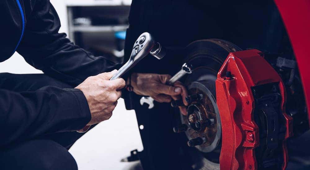 A mechanic is shown working on brakes at a Toyota service center near Lockport.