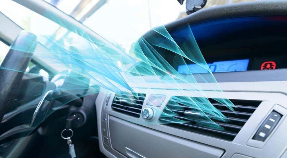 Simulated AC air is shown flowing out of a vehicles vent.