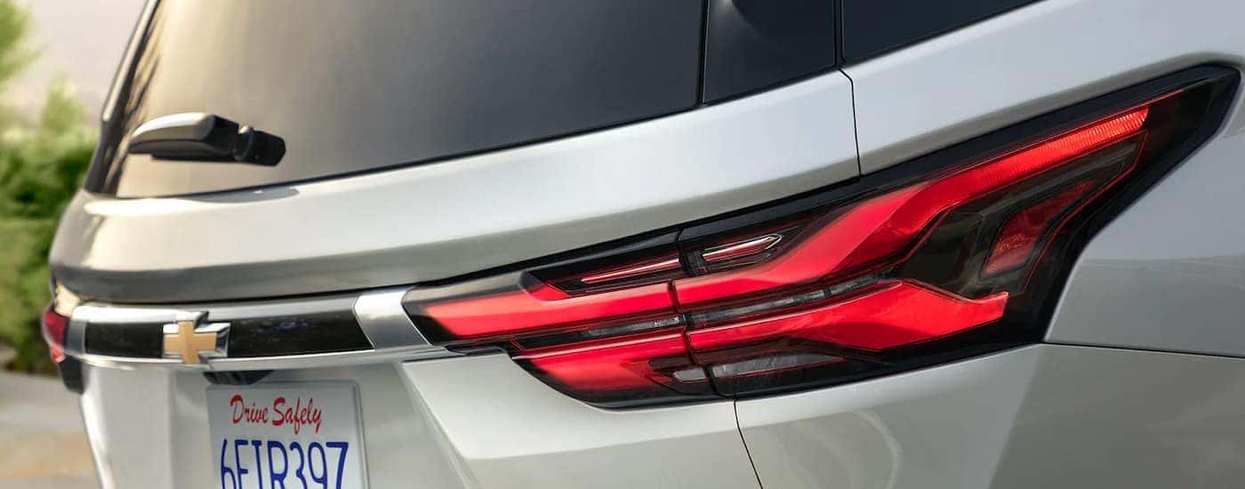 A close up of the rear brakelights on a silver 2023 Chevy Traverse is shown at a used Chevy dealer.