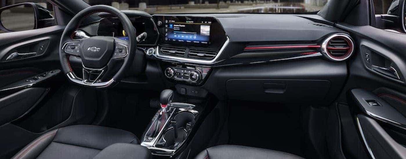 The black interior of a 2024 Chevy Trax RS is shown from the passenger seat.