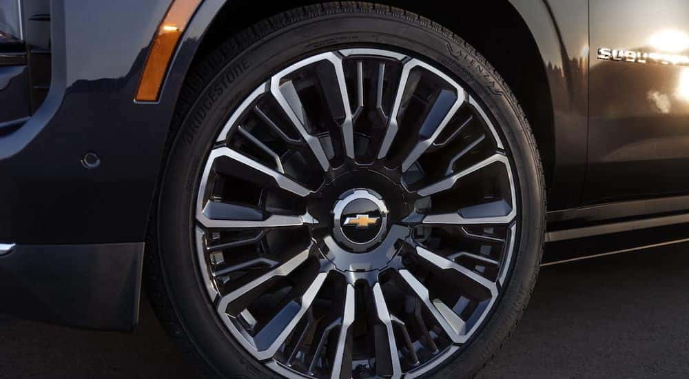 A close-up of the wheel of a 2025 Chevy Suburban High Country is shown.
