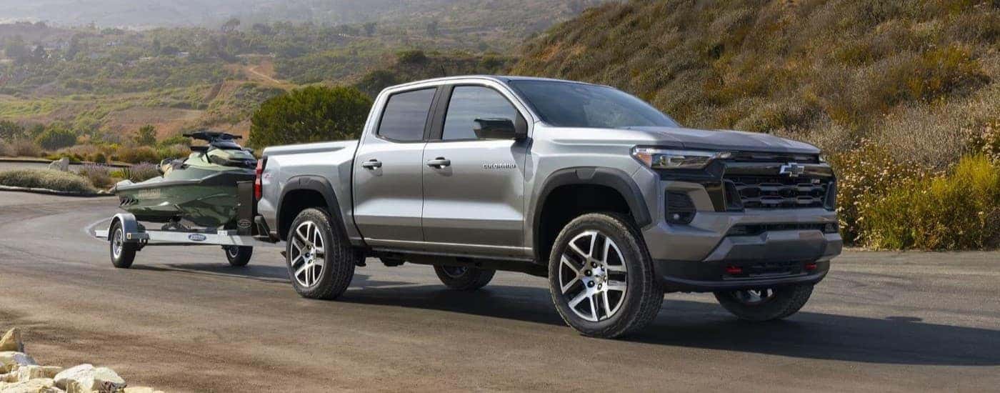 A grey 2023 Chevy Colorado Z71 towing a jetski.