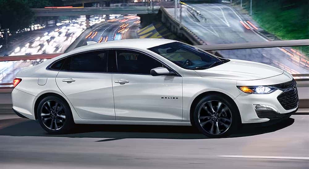 A white 2025 Chevy Malibu driving.